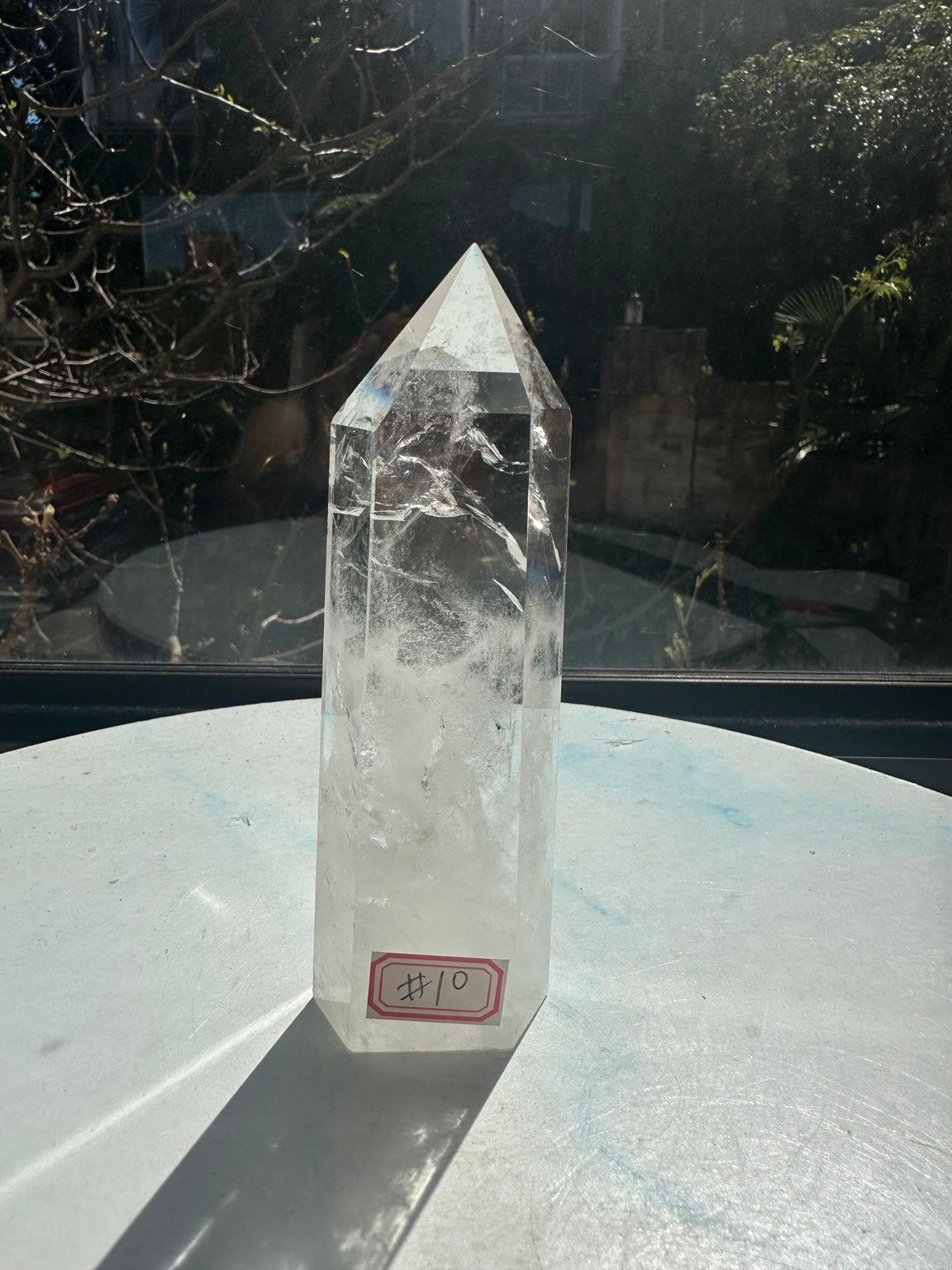 Brazilian clear quartz tower number 10, 280g and 14cm tall: front angled view with the number 10 label and natural white veils.