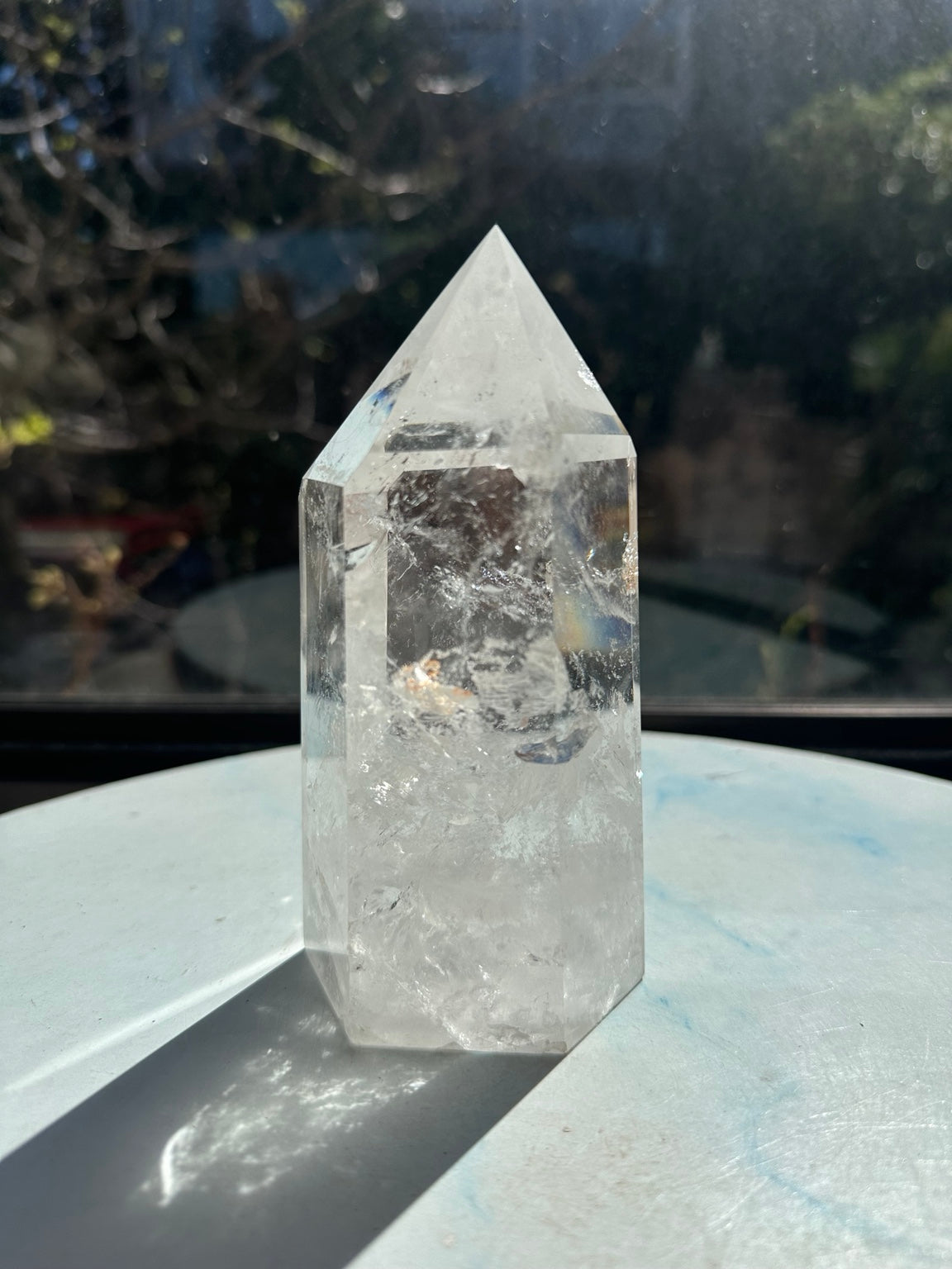 Reverse view of crystal tower number 7 showing white internal textures and small warm-coloured inclusions.