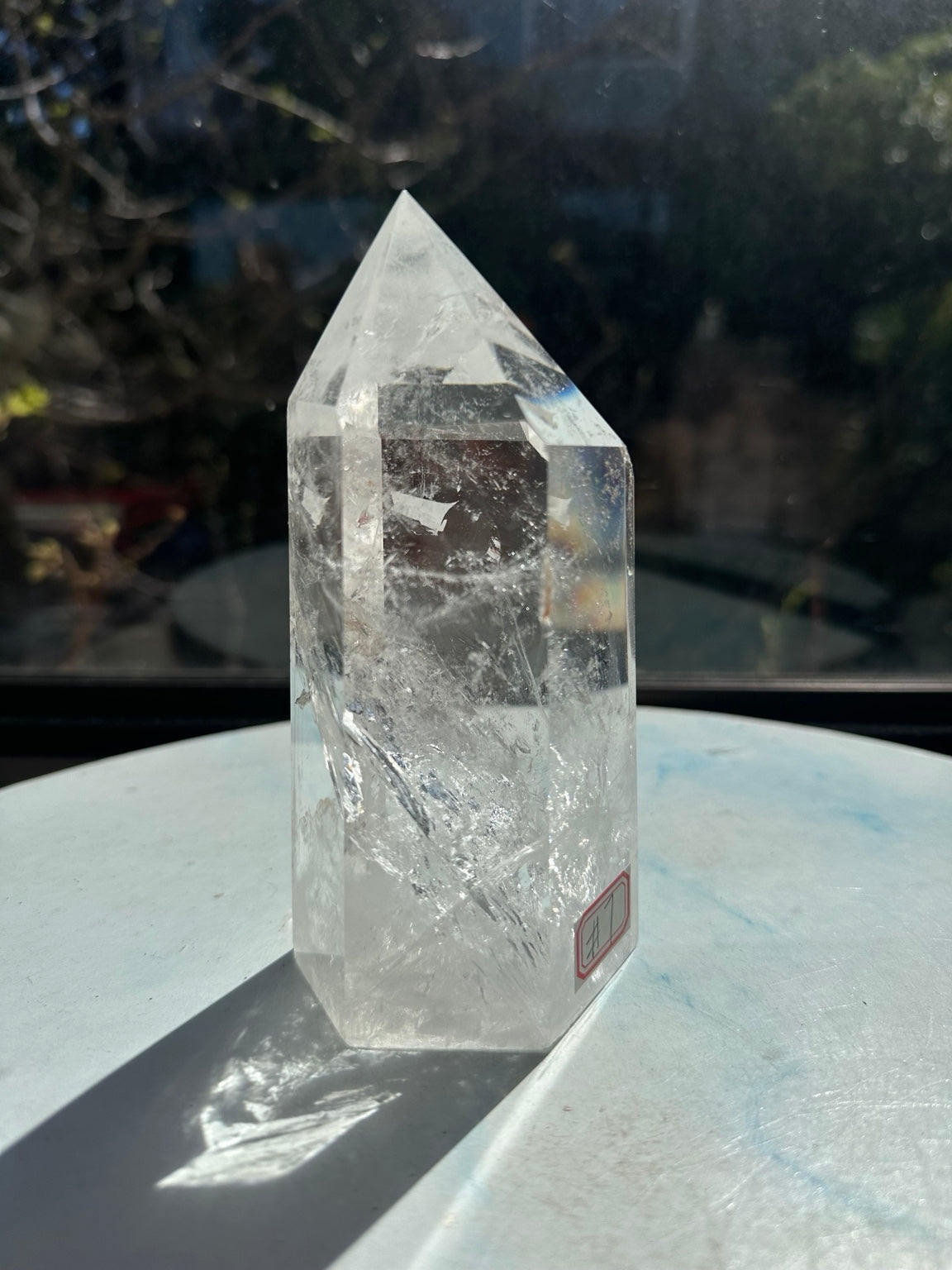 Close angled view of the quartz tower showing its point, delicate fracture patterns and number 7 label at the side.