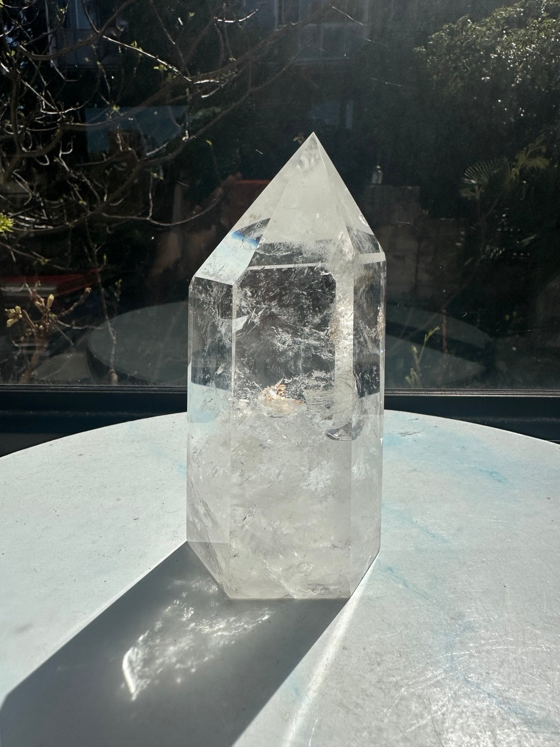 Opposite view of the Brazilian clear quartz tower showing natural white veils and small warm-coloured inclusions.