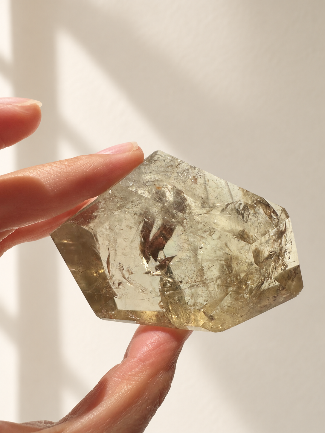 Natural Brazilian citrine 118g exact piece #12 view 4 in soft natural daylight against warm ivory wall