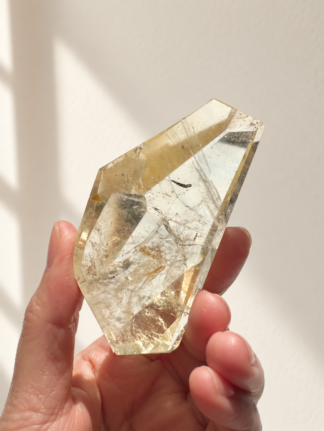 Exact citrine piece #7, 128g — main photo with soft indoor natural light and cream wall background