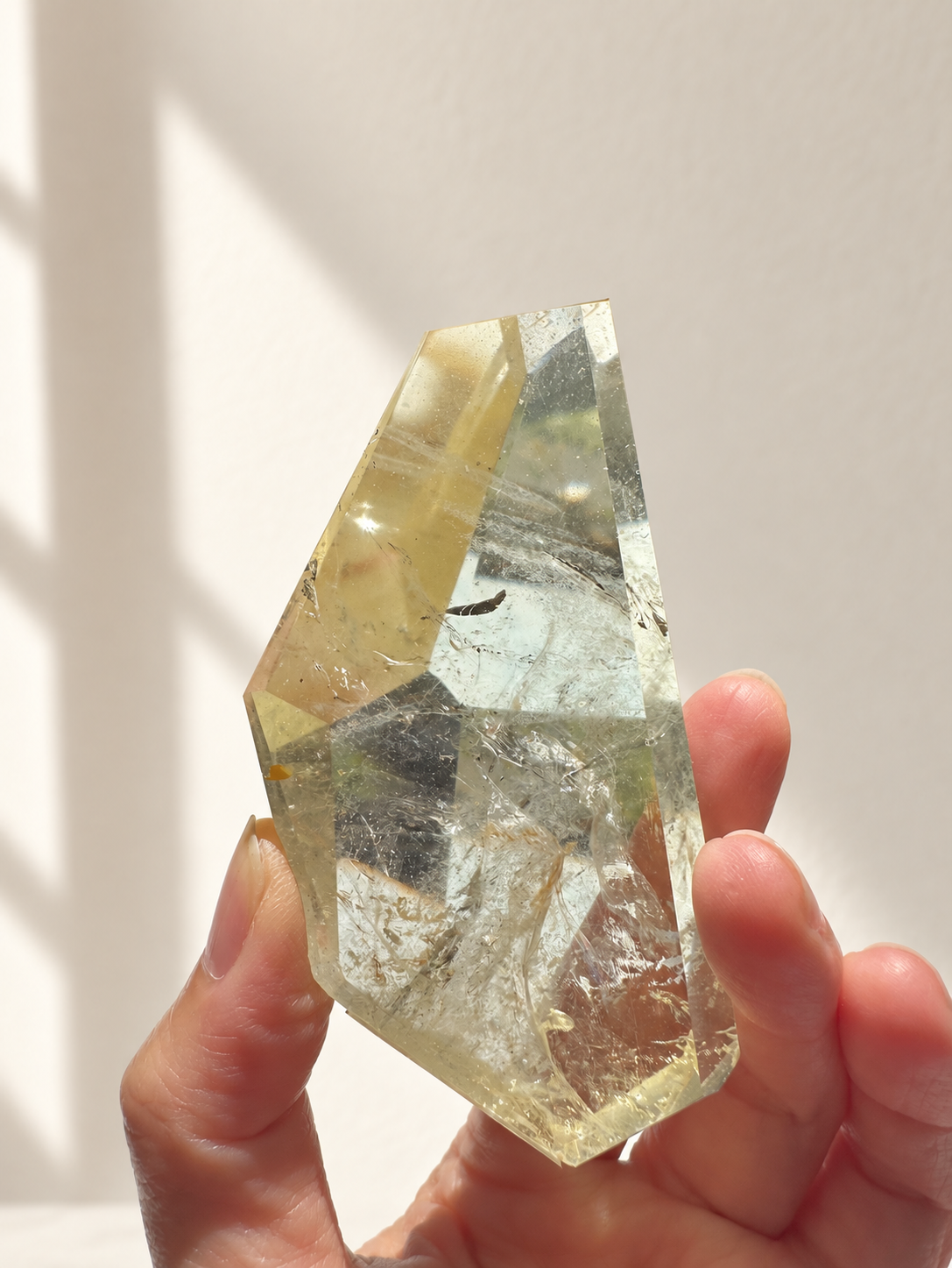 Natural Brazilian citrine 128g exact piece #7 view 11 in soft natural daylight against warm ivory wall