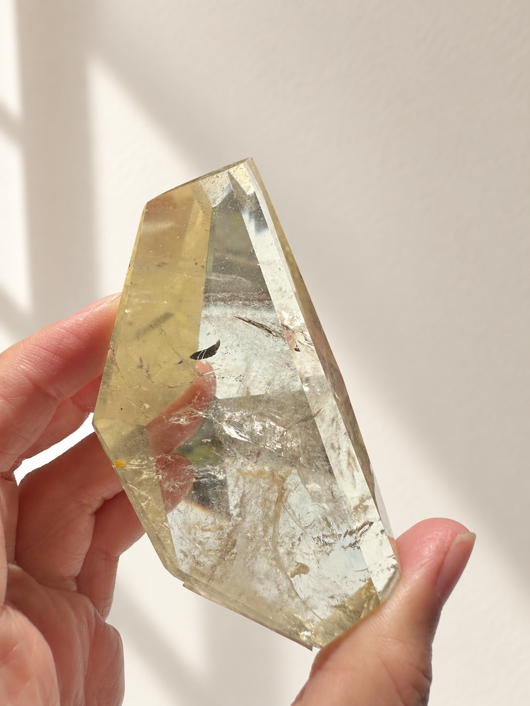 Natural Brazilian citrine 128g exact piece #7 view 12 in soft natural daylight against warm ivory wall