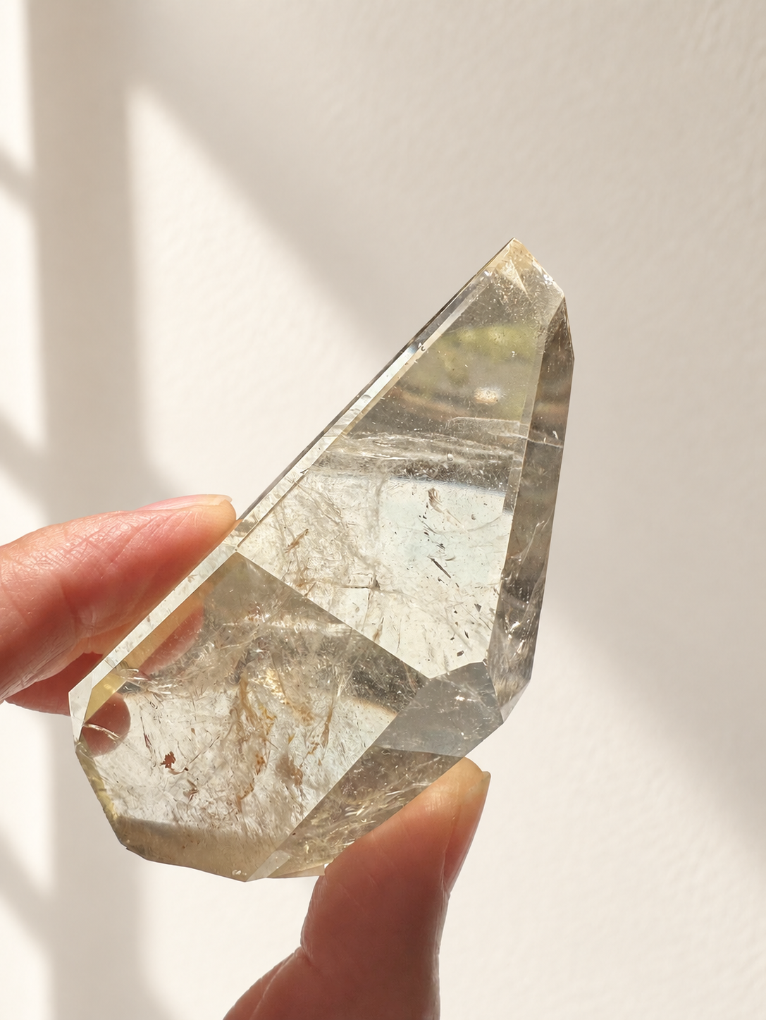 Natural Brazilian citrine 128g exact piece #7 view 13 in soft natural daylight against warm ivory wall