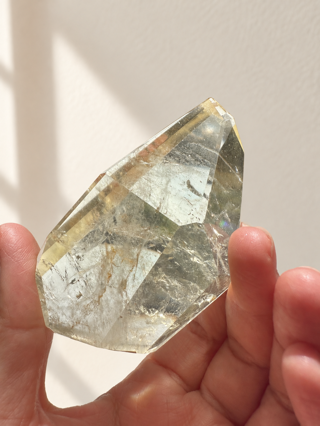 Natural Brazilian citrine 128g exact piece #7 view 2 in soft natural daylight against warm ivory wall