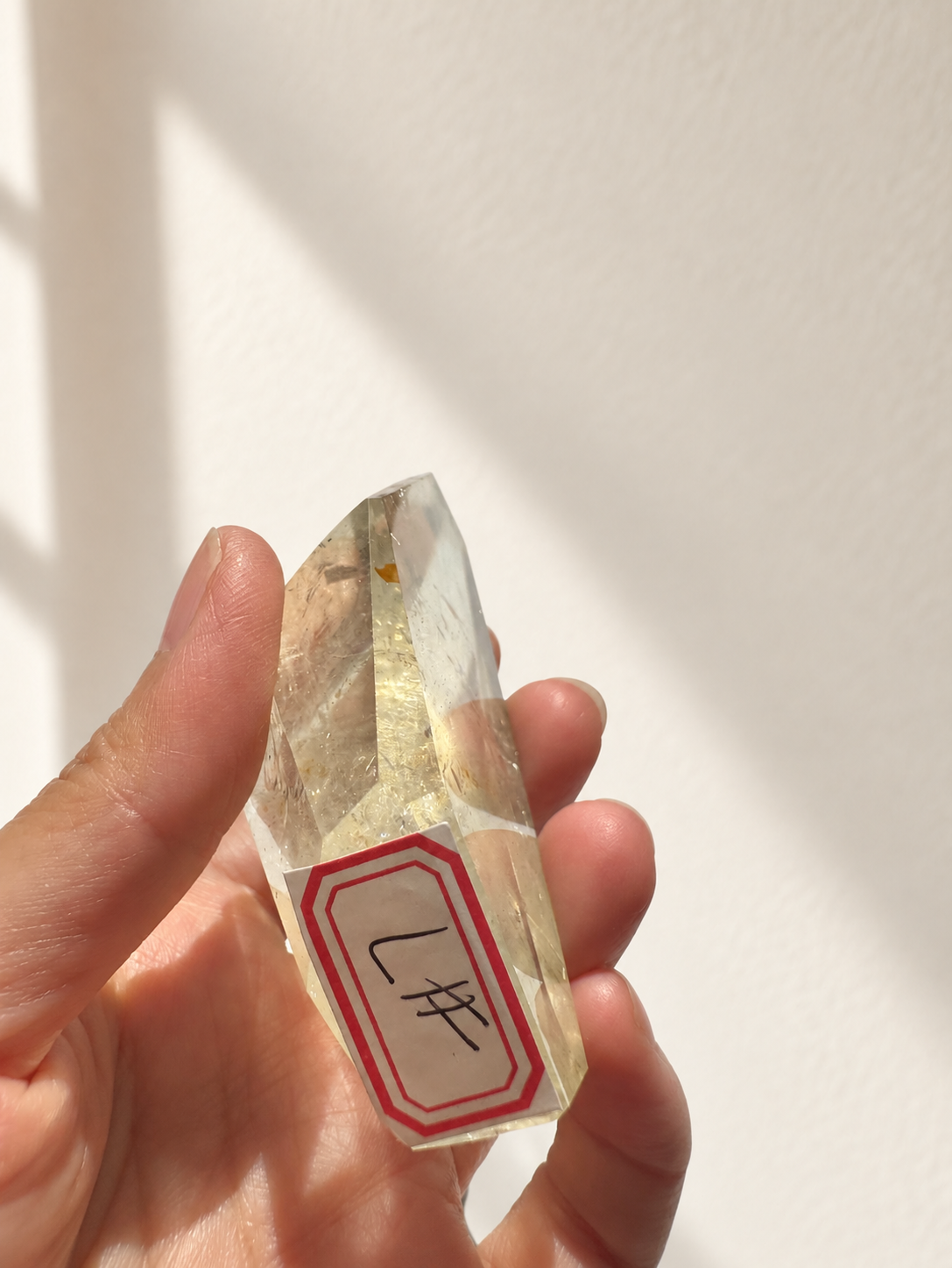 Natural Brazilian citrine 128g exact piece #7 view 3 in soft natural daylight against warm ivory wall