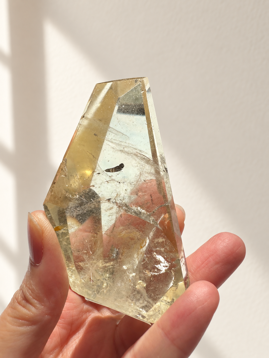Natural Brazilian citrine 128g exact piece #7 view 4 in soft natural daylight against warm ivory wall