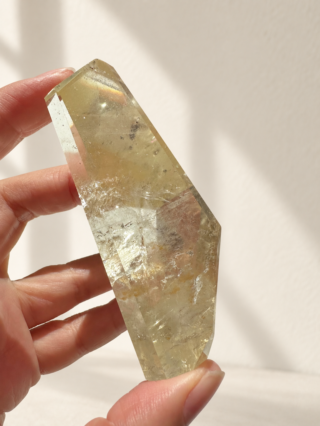 Natural Brazilian citrine 128g exact piece #7 view 6 in soft natural daylight against warm ivory wall