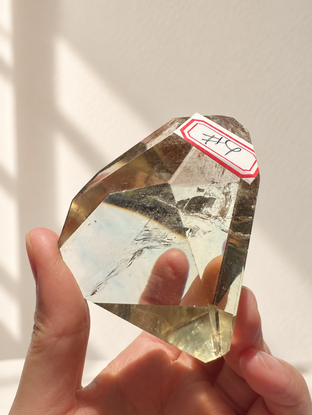 Natural Brazilian citrine 129g exact piece #4 view 10 in soft natural daylight against warm ivory wall