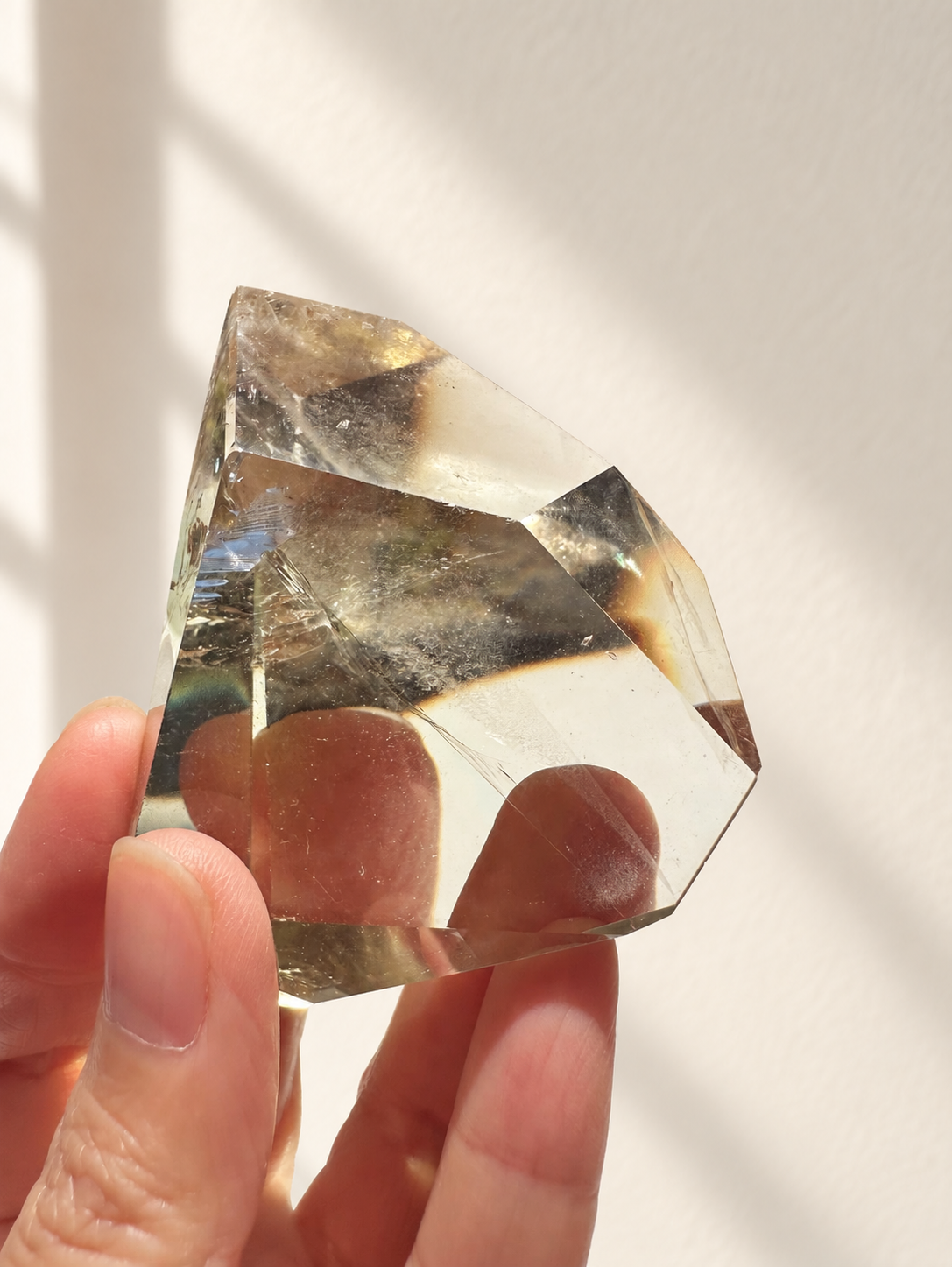Natural Brazilian citrine 129g exact piece #4 view 11 in soft natural daylight against warm ivory wall