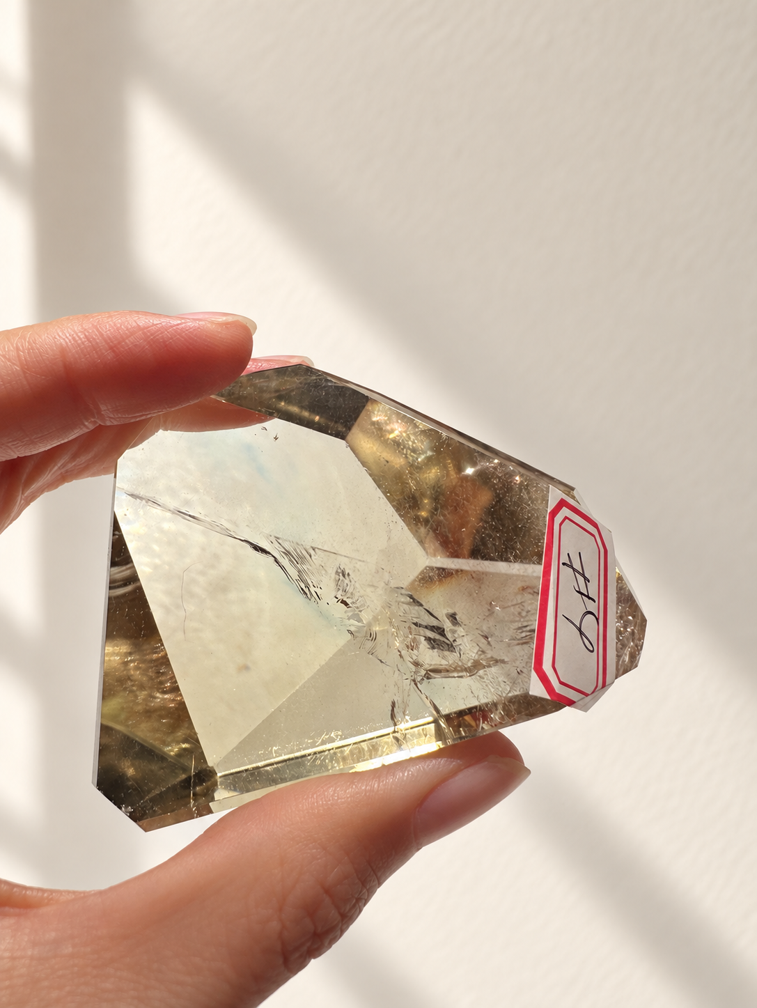 Natural Brazilian citrine 129g exact piece #4 view 3 in soft natural daylight against warm ivory wall