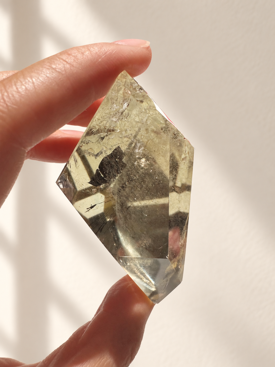 Natural Brazilian citrine 129g exact piece #4 view 6 in soft natural daylight against warm ivory wall