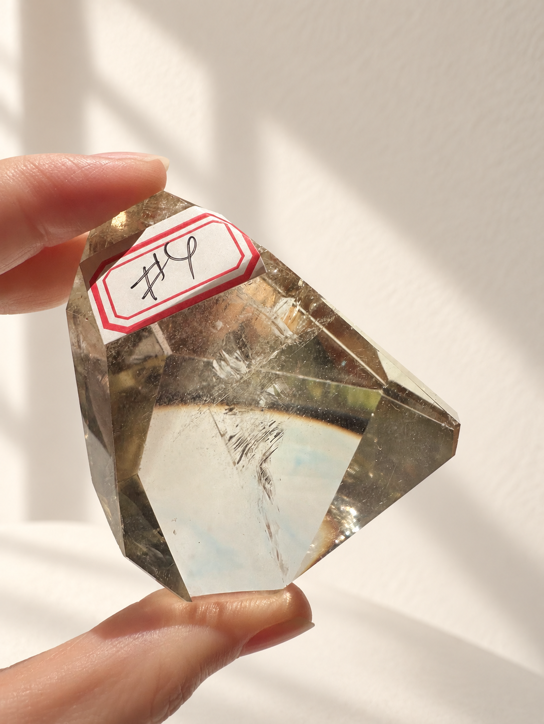 Natural Brazilian citrine 129g exact piece #4 view 7 in soft natural daylight against warm ivory wall