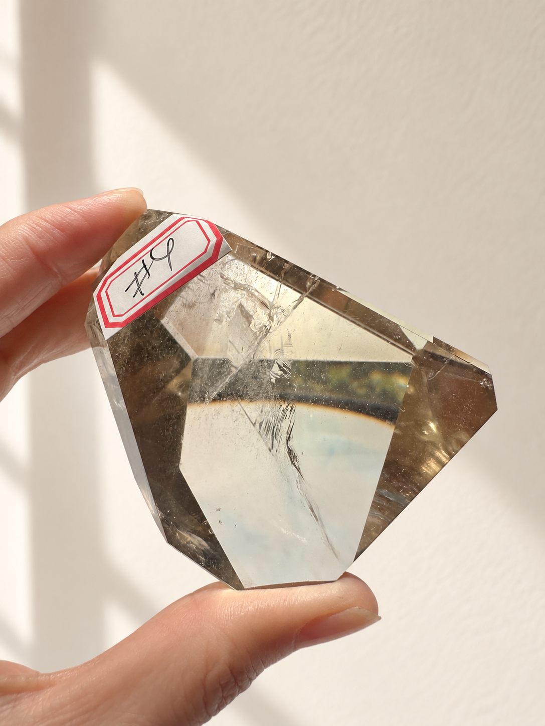 Natural Brazilian citrine 129g exact piece #4 view 8 in soft natural daylight against warm ivory wall
