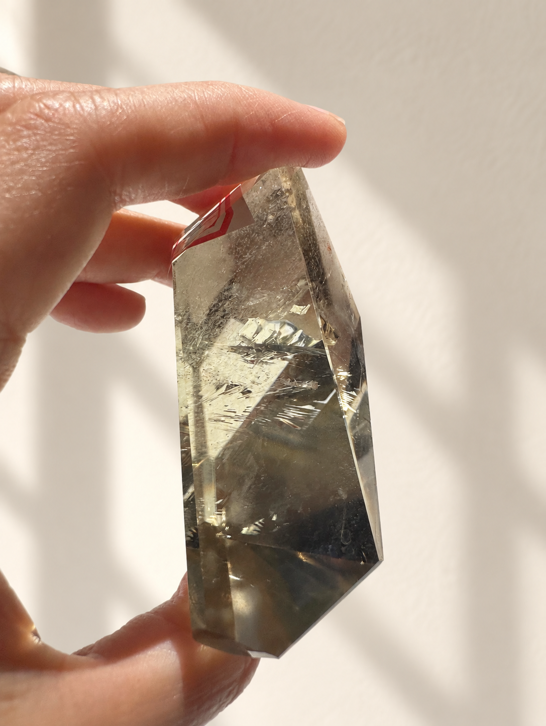 Natural Brazilian citrine 129g exact piece #4 view 9 in soft natural daylight against warm ivory wall