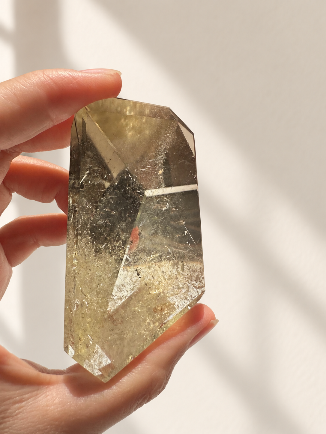 Natural Brazilian citrine 135g exact piece #6 view 4 in soft natural daylight against warm ivory wall
