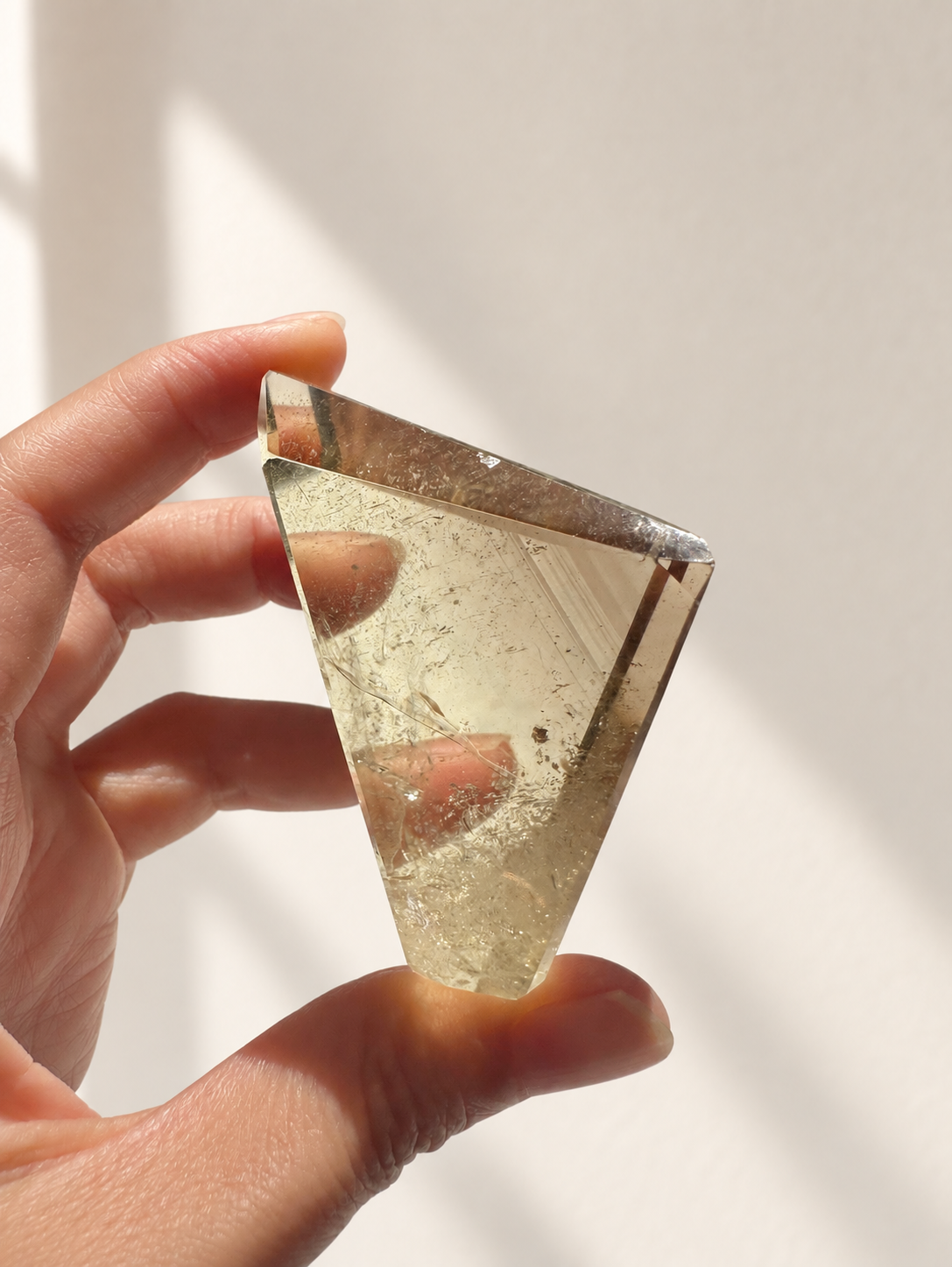 Natural Brazilian citrine 135g exact piece #6 view 6 in soft natural daylight against warm ivory wall
