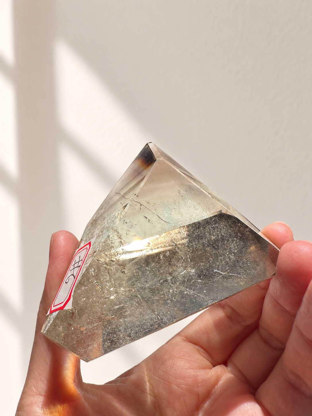 Natural Brazilian citrine 135g exact piece #6 view 8 in soft natural daylight against warm ivory wall