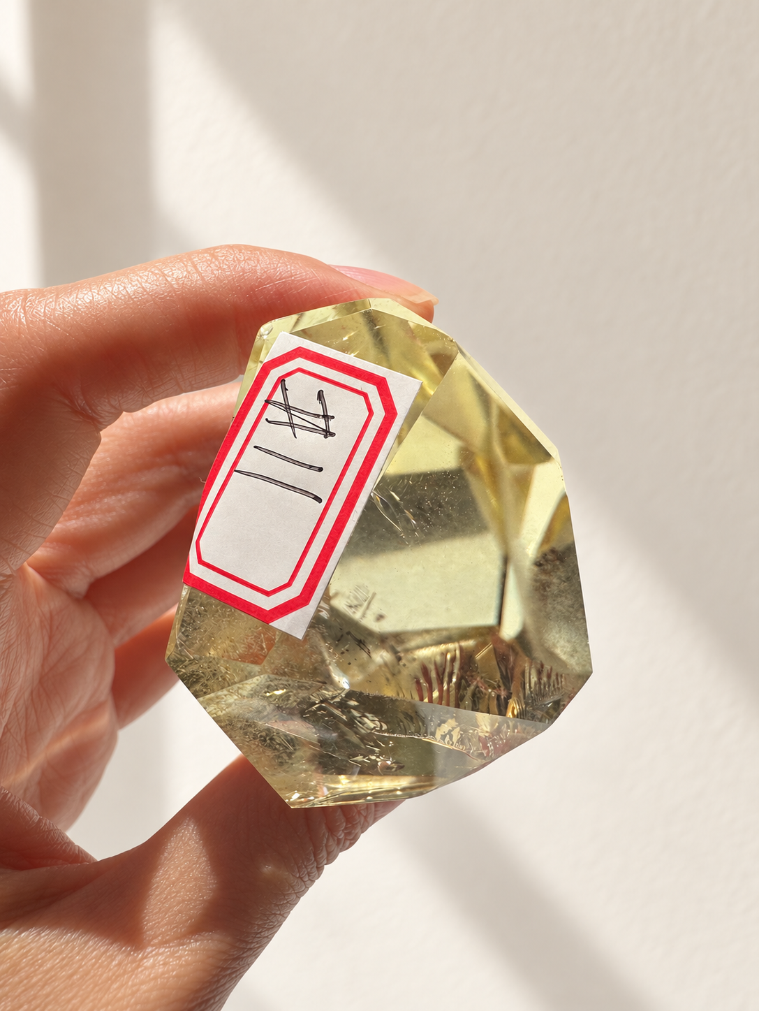 Natural Brazilian citrine 144g exact piece #11 view 10 in soft natural daylight against warm ivory wall