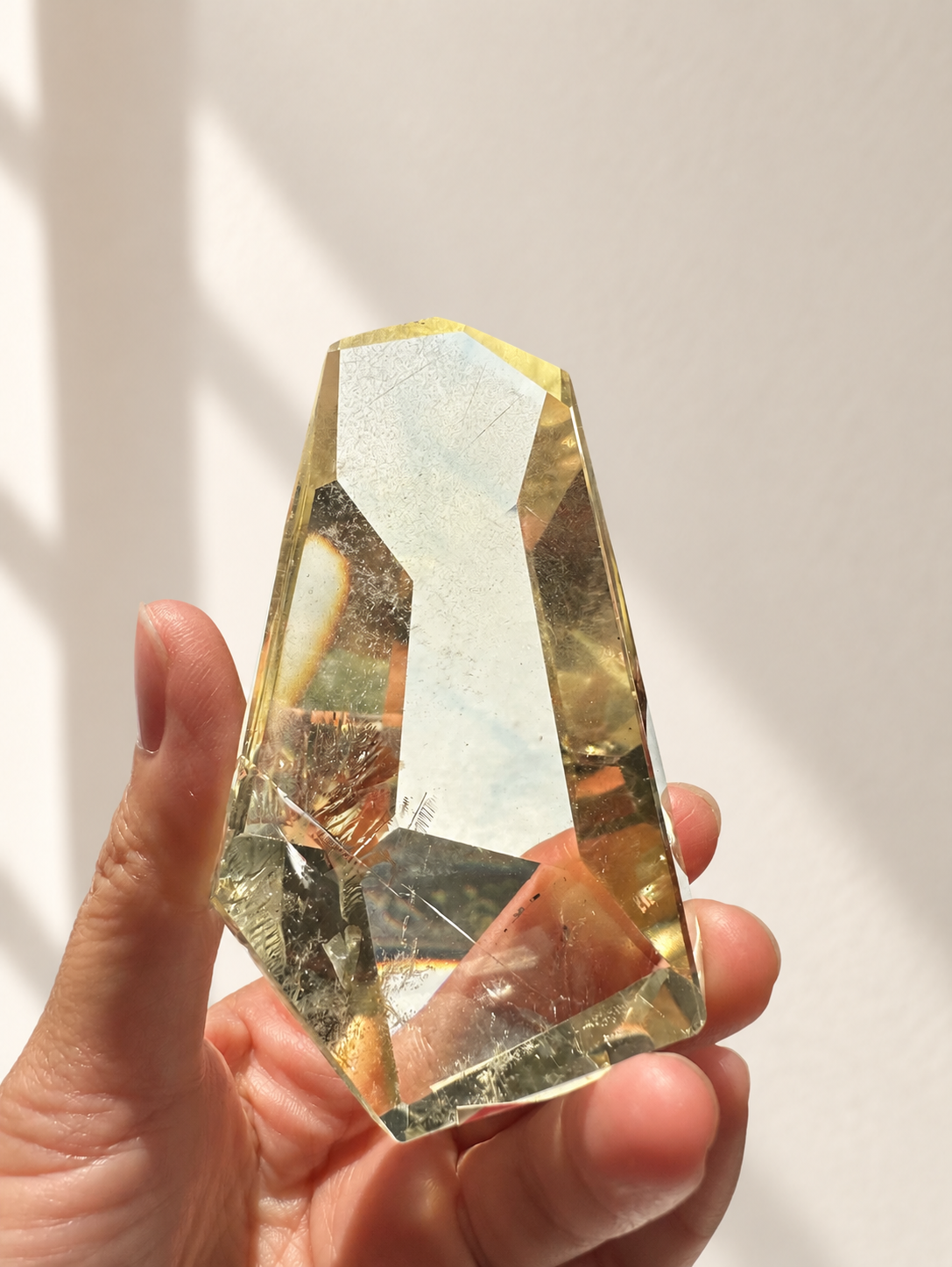 Natural Brazilian citrine 144g exact piece #11 view 11 in soft natural daylight against warm ivory wall