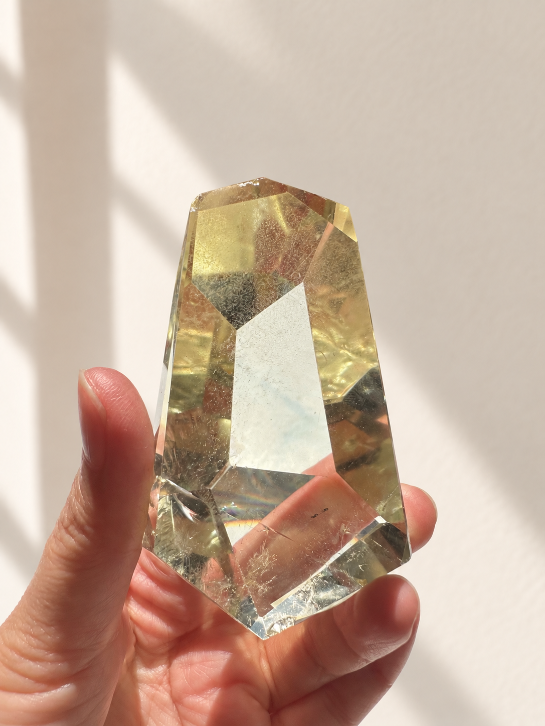 Natural Brazilian citrine 144g exact piece #11 view 2 in soft natural daylight against warm ivory wall