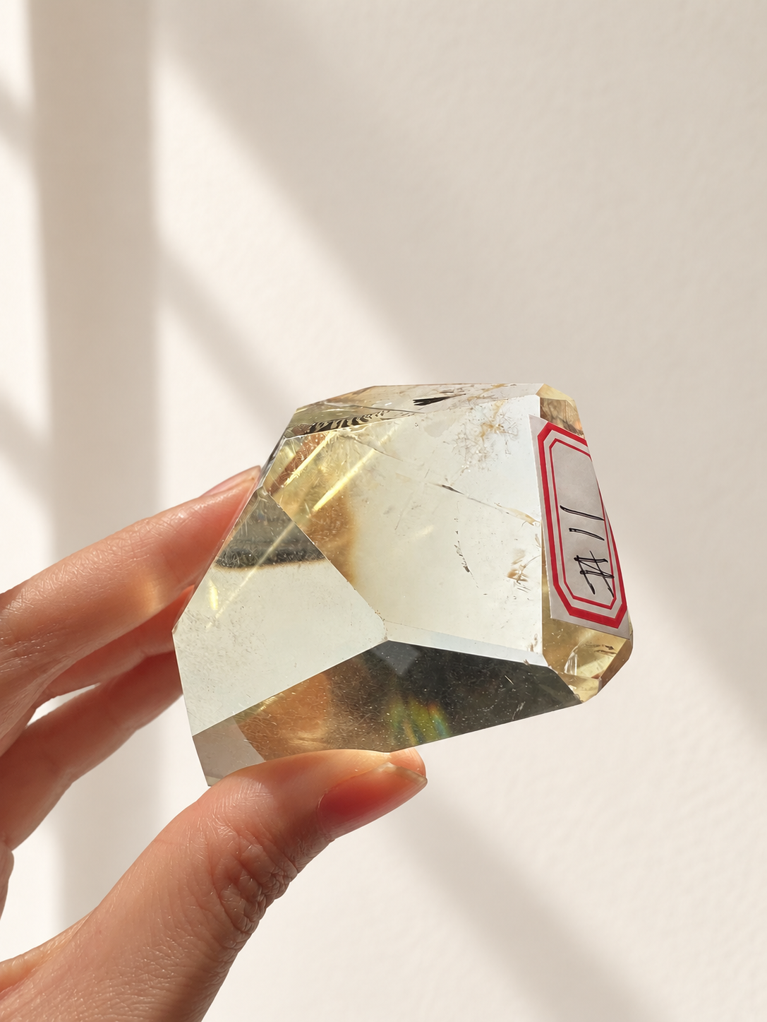 Natural Brazilian citrine 144g exact piece #11 view 3 in soft natural daylight against warm ivory wall