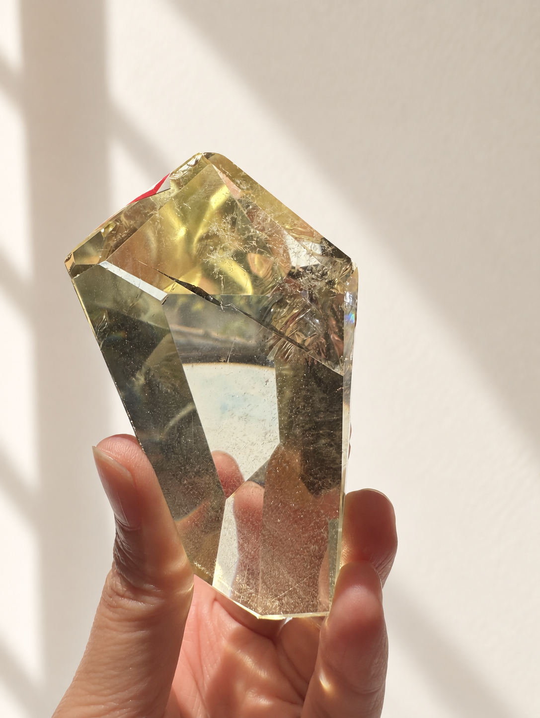 Natural Brazilian citrine 144g exact piece #11 view 5 in soft natural daylight against warm ivory wall
