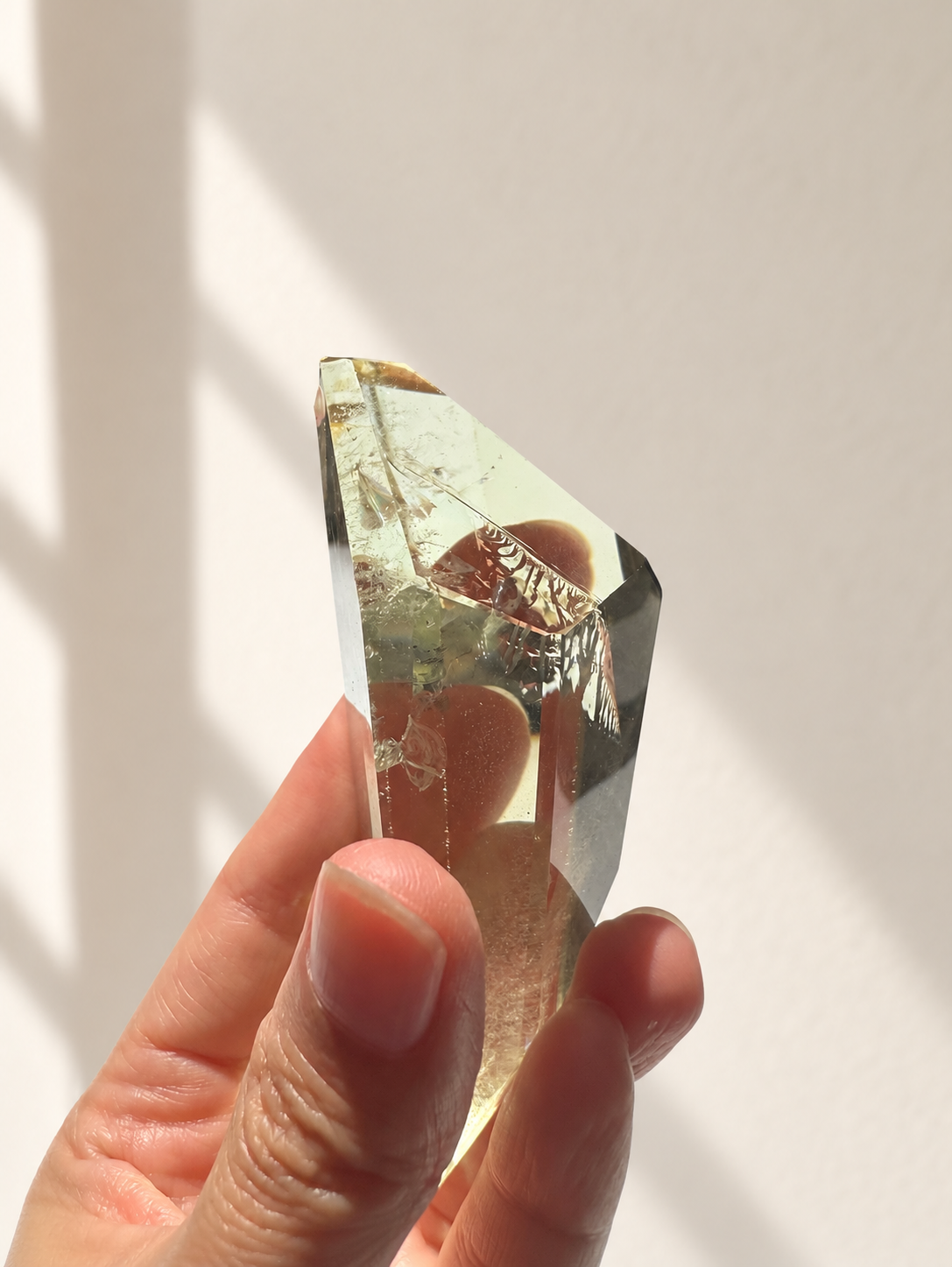 Natural Brazilian citrine 144g exact piece #11 view 7 in soft natural daylight against warm ivory wall