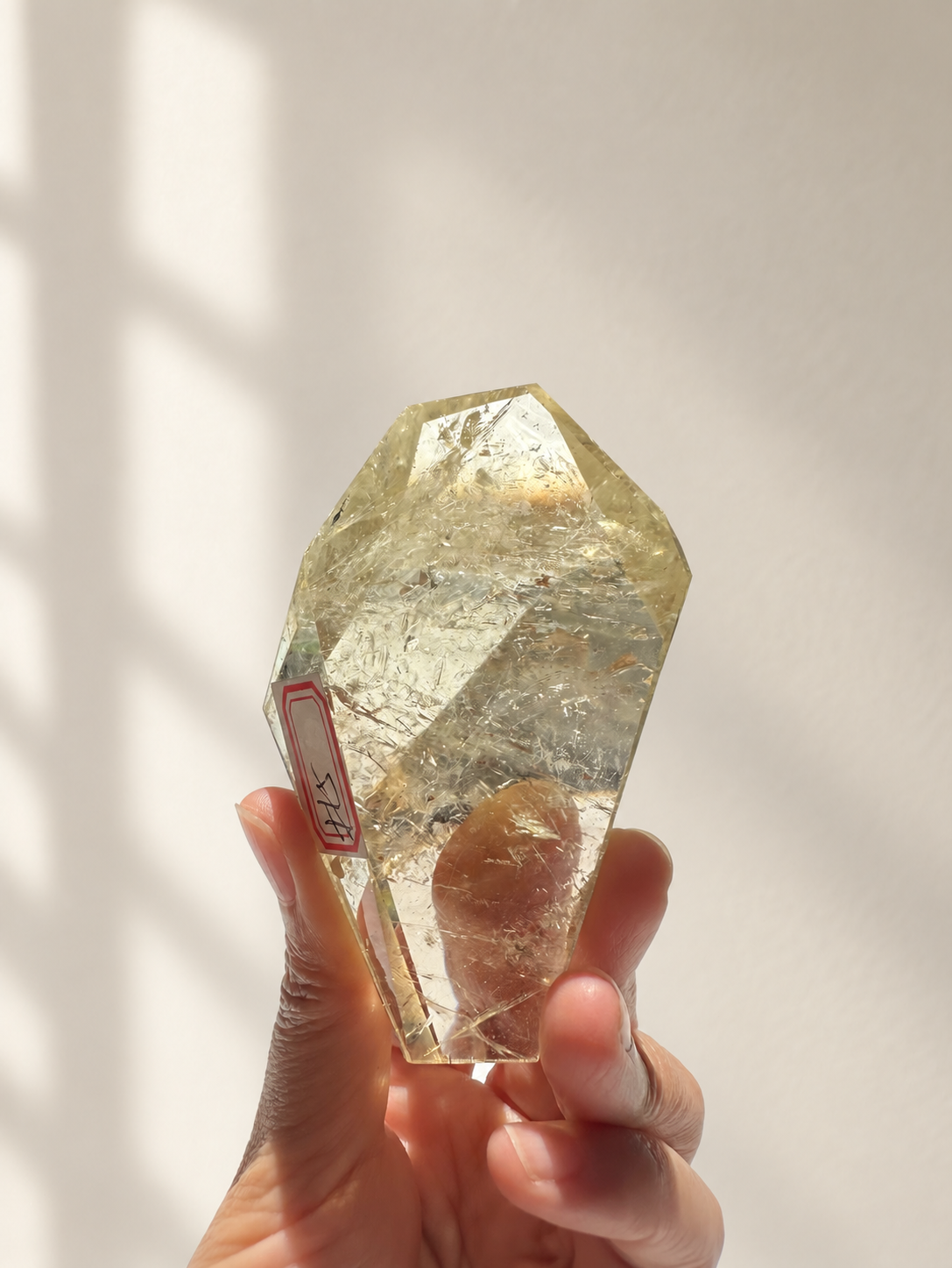 Natural Brazilian citrine 157g exact piece #5 view 6 in soft natural daylight against warm ivory wall