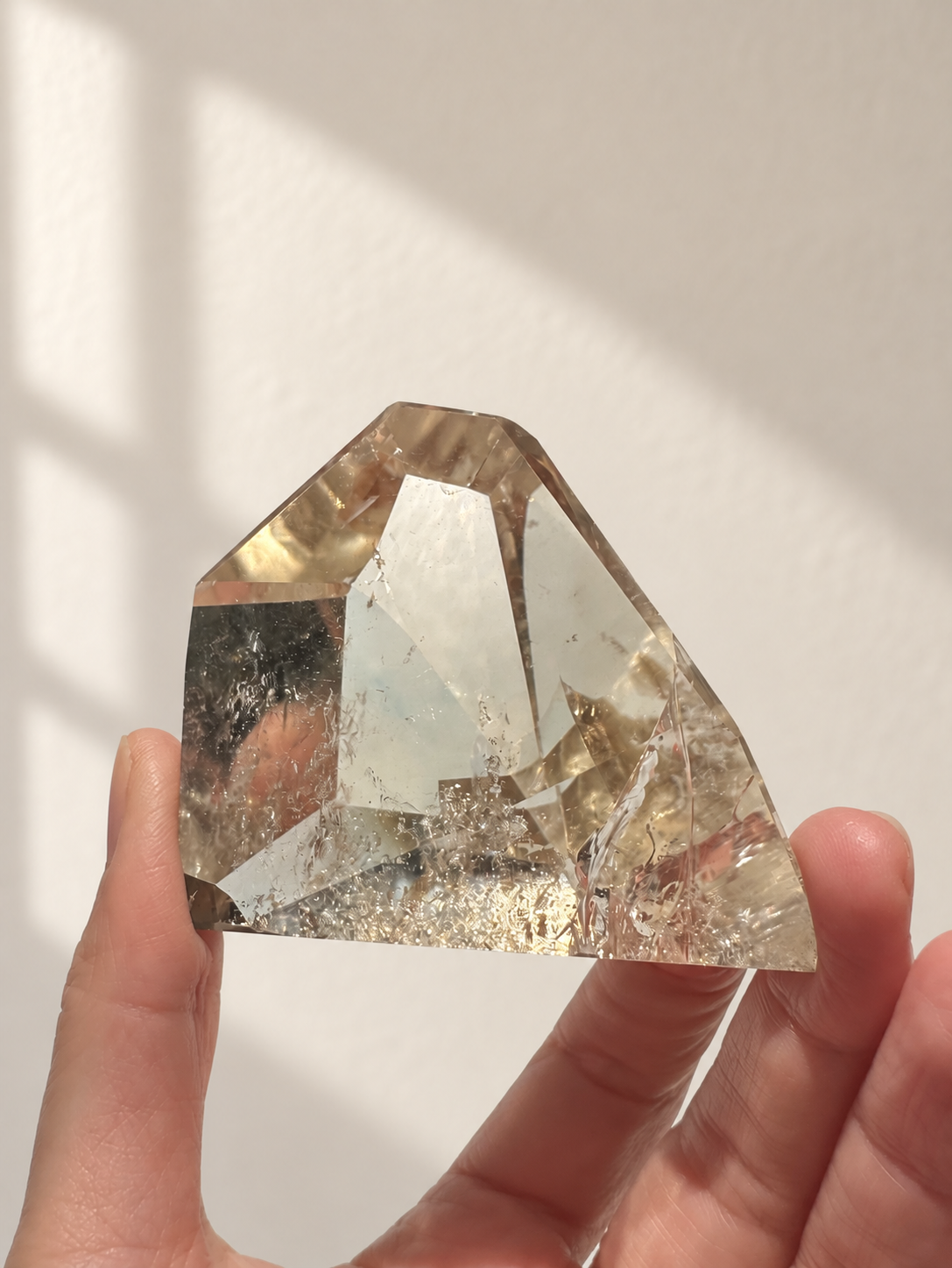 Natural Brazilian citrine 164g exact piece #9 view 16 in soft natural daylight against warm ivory wall