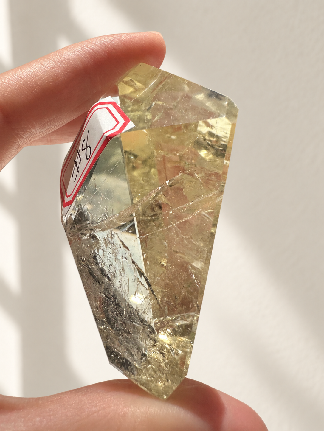 Natural Brazilian citrine 78g exact piece #8 view 3 in soft natural daylight against warm ivory wall