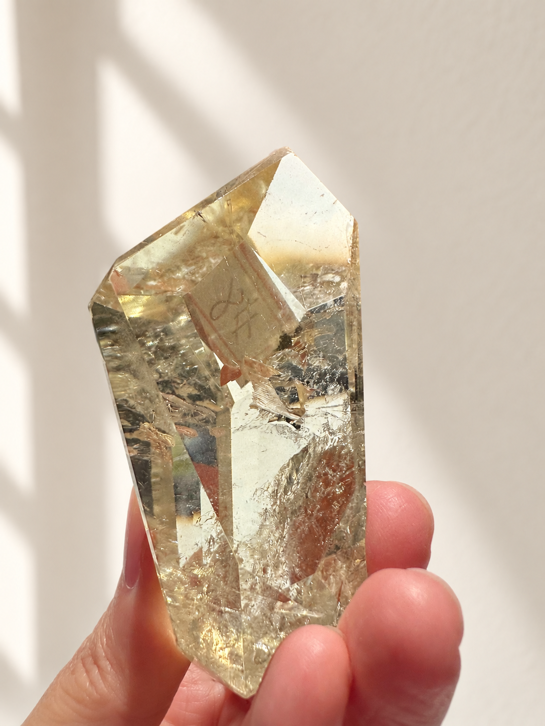 Natural Brazilian citrine 78g exact piece #8 view 6 in soft natural daylight against warm ivory wall