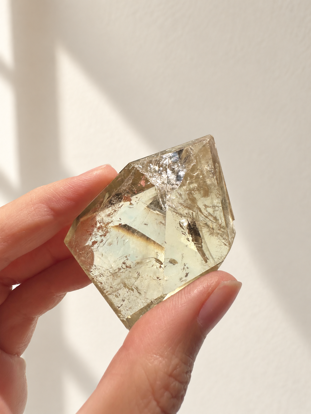 Exact citrine piece #3, 81g — main photo with soft indoor natural light and cream wall background