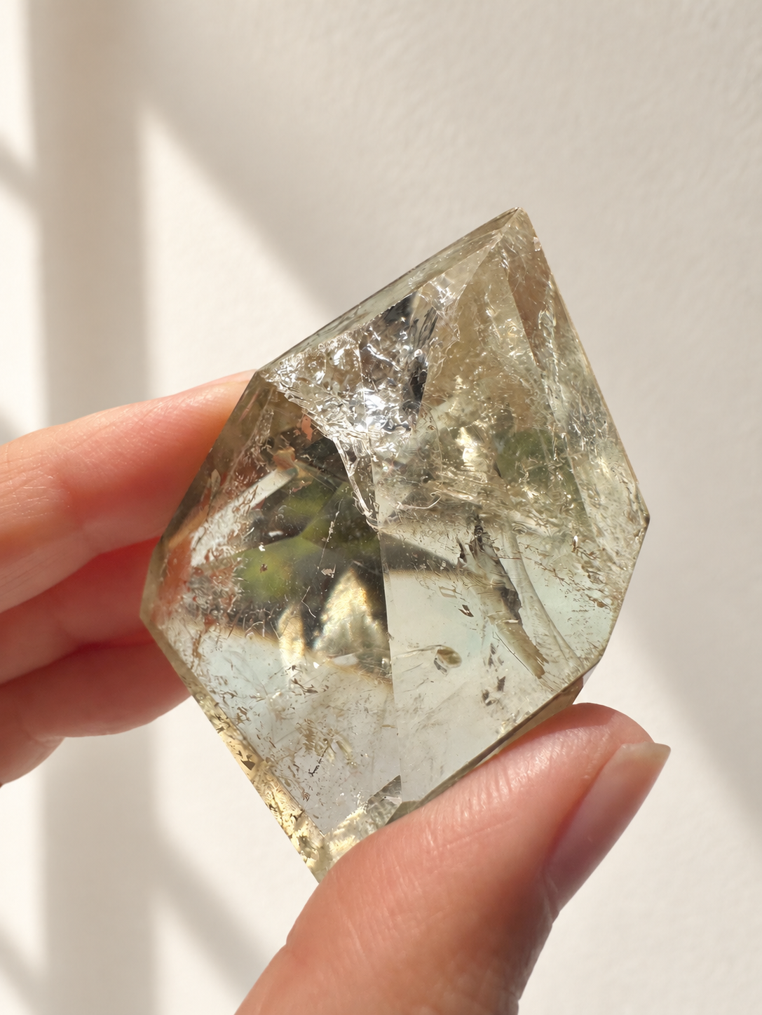 Natural Brazilian citrine 81g exact piece #3 view 2 in soft natural daylight against warm ivory wall
