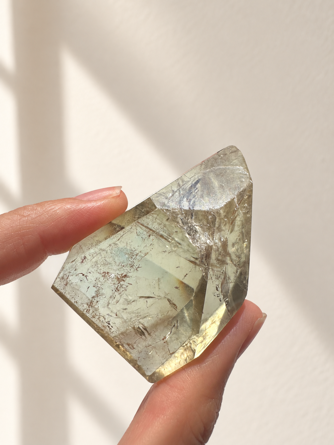 Natural Brazilian citrine 81g exact piece #3 view 4 in soft natural daylight against warm ivory wall