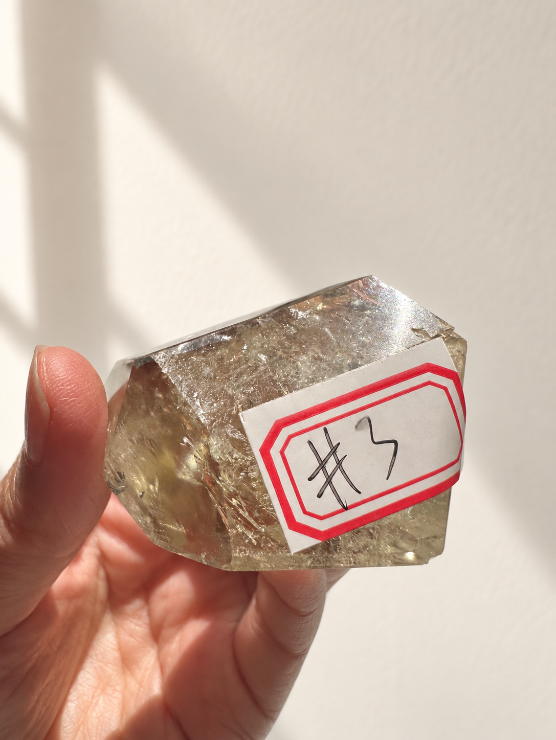 Natural Brazilian citrine 81g exact piece #3 view 5 in soft natural daylight against warm ivory wall