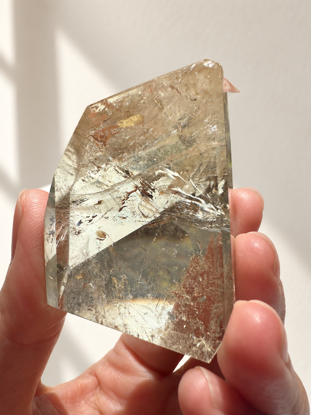 Natural Brazilian citrine 81g exact piece #3 view 6 in soft natural daylight against warm ivory wall