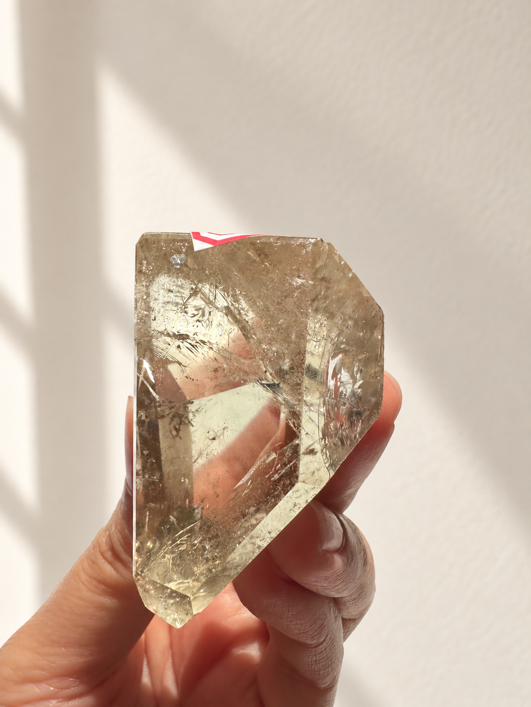 Natural Brazilian citrine 81g exact piece #3 view 7 in soft natural daylight against warm ivory wall