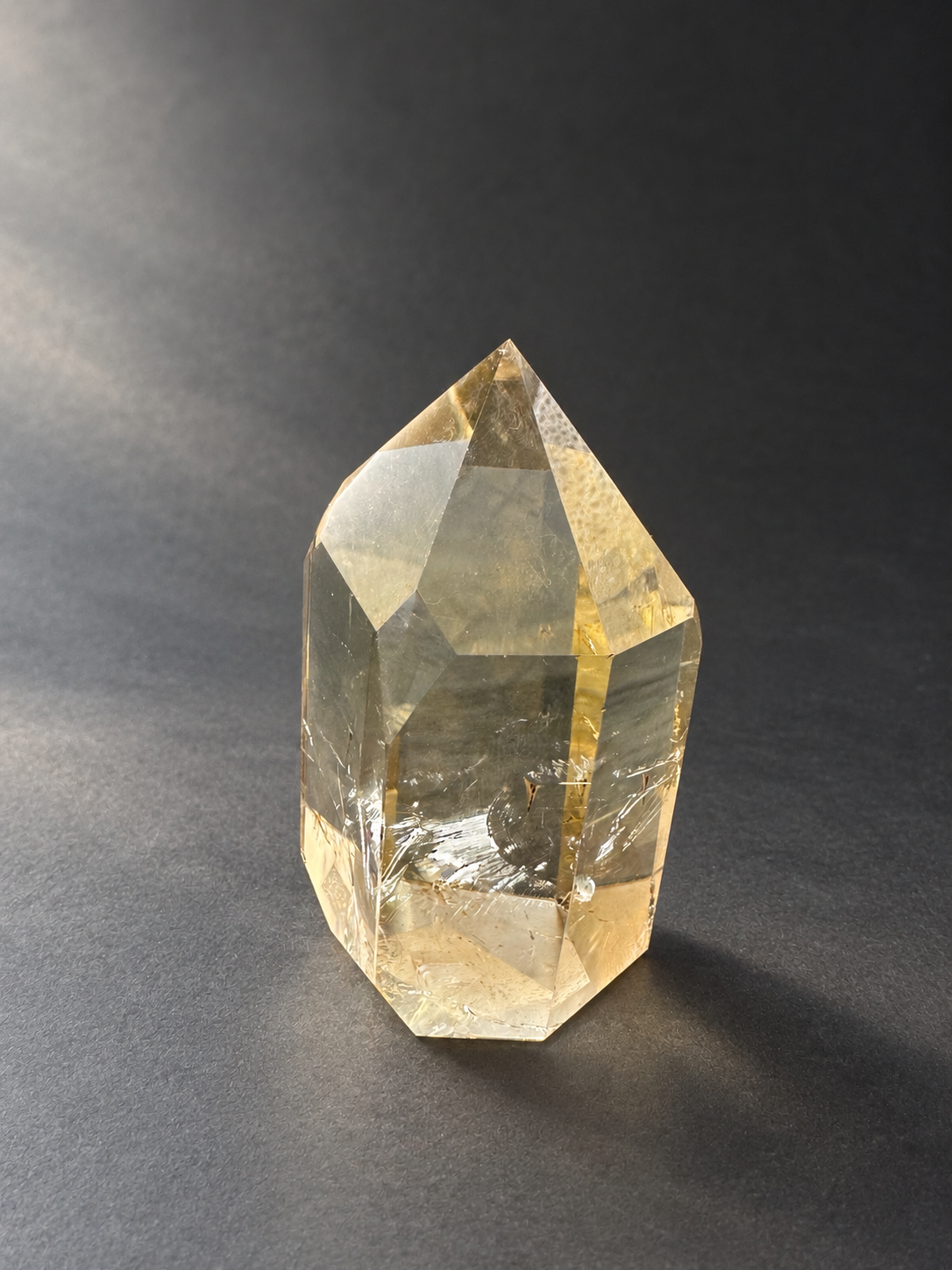 Natural unheated Congo citrine point No.12, 194g, soft side daylight — angle 8