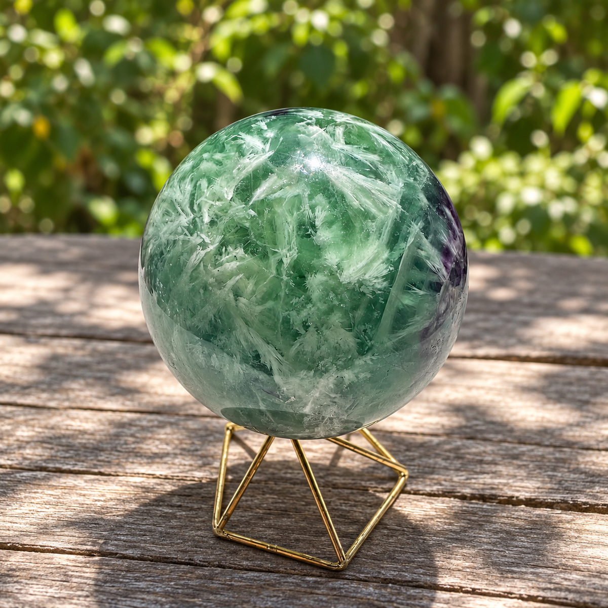 Feather-rich green face of 71mm fluorite sphere No.4 with white plumes and a purple side zone