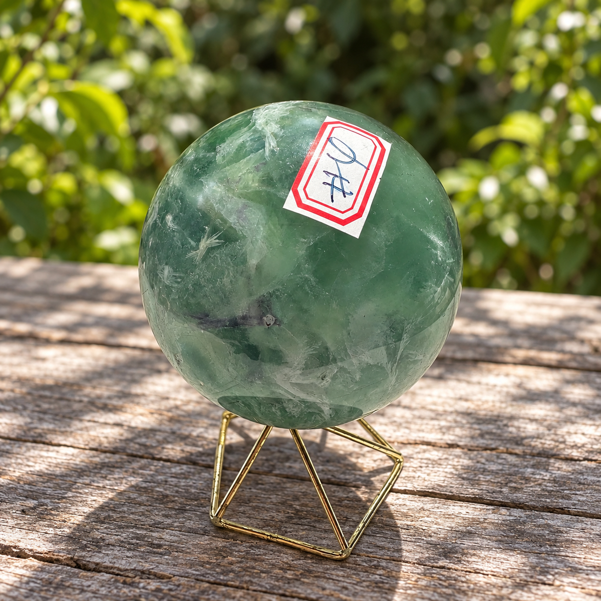 Number 4 identification label on the green reverse of the 583g feather fluorite sphere