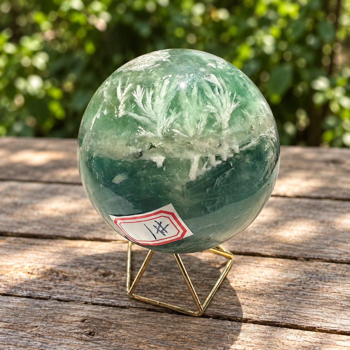 Feather fluorite sphere No.1 showing white plume formations above a deep green band and its number label