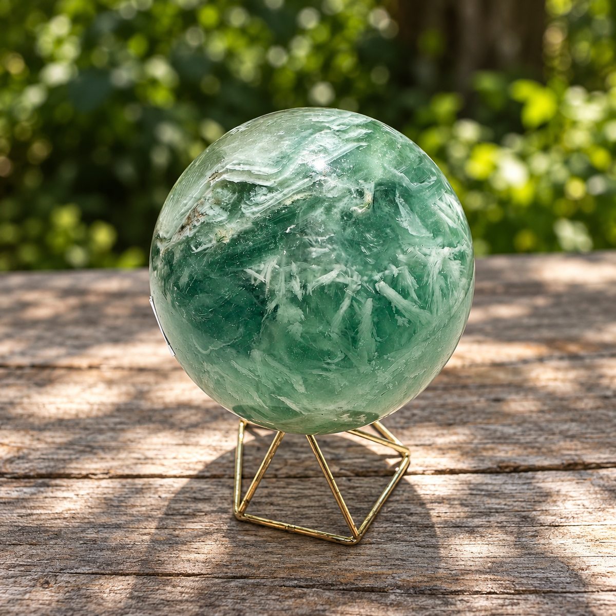 Alternate angle of green feather fluorite sphere with layered white bands and branching internal formations