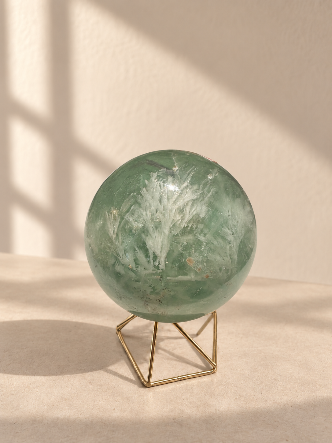 Feather fluorite sphere No.2 showing branching white plumes, tan inclusions and internal lines