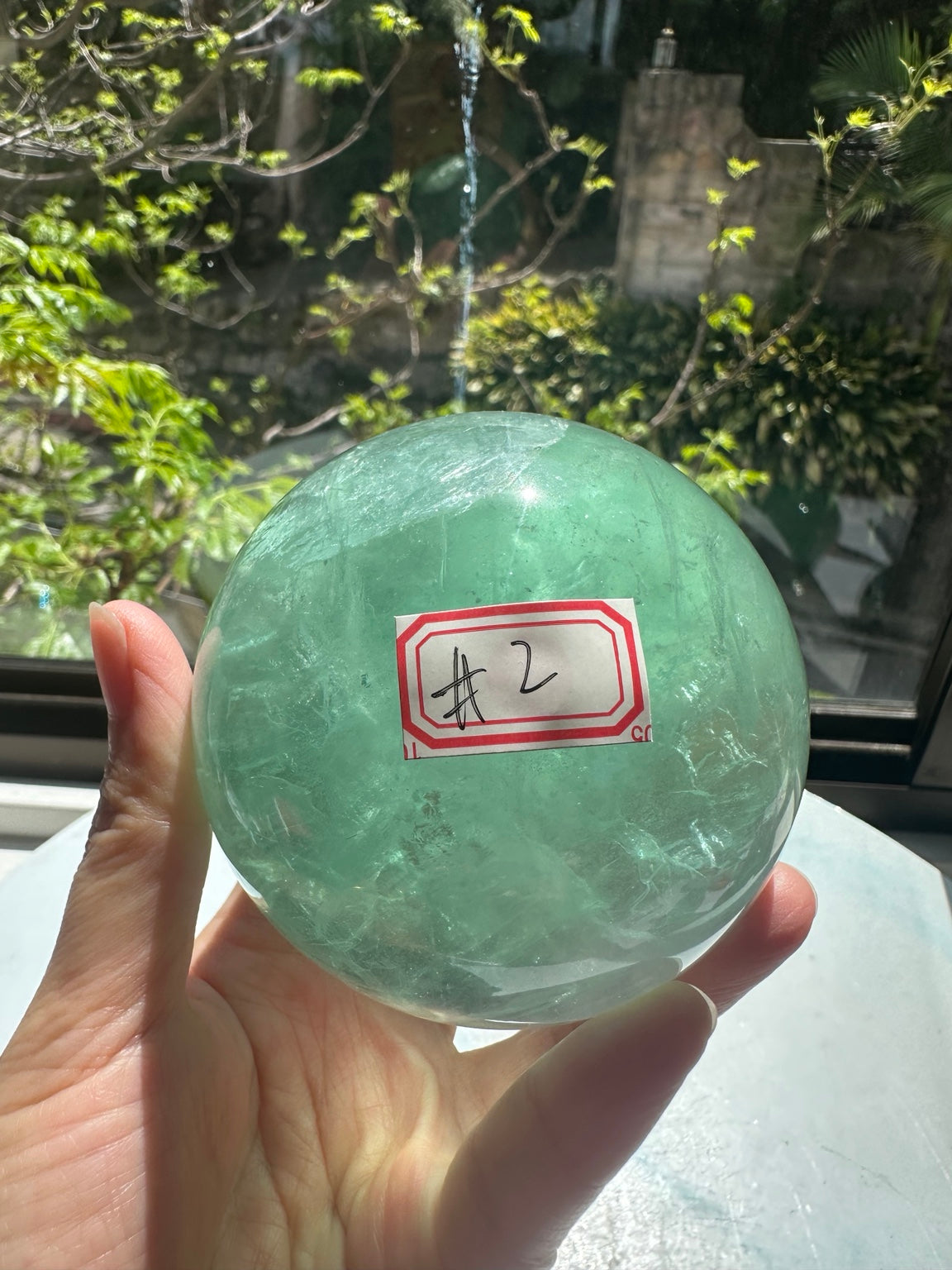 Unedited natural-light original of Madagascar green fluorite sphere #2 787g, view 1