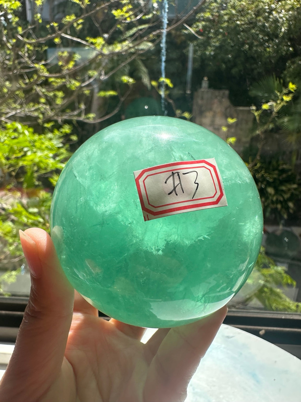 Unedited natural-light original of Madagascar green fluorite sphere #3 725g, view 1