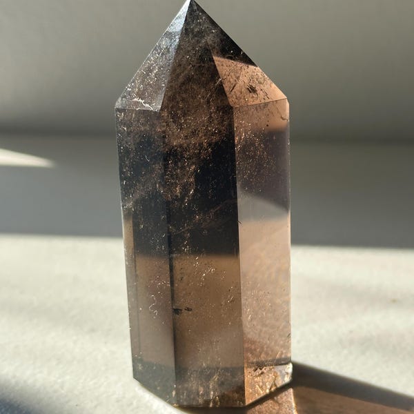 Polished Brazilian Smoky Quartz crystal tower showing warm smoky-brown tones