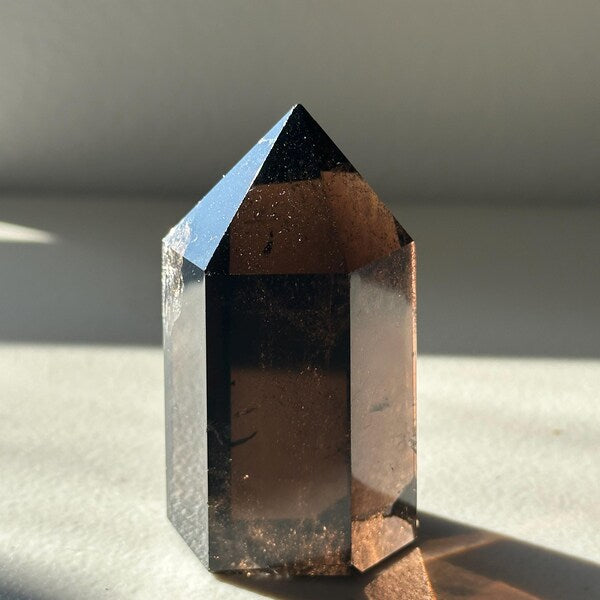Brazilian Smoky Quartz tower with light-catching polished faces and internal veils