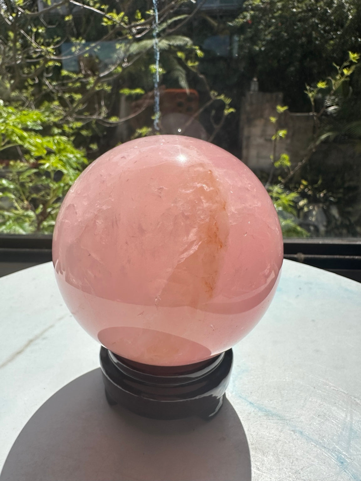 Unedited natural-light photo of exact rose quartz sphere #2, 1.42kg, 10.3cm / approximately 4.06 inches
